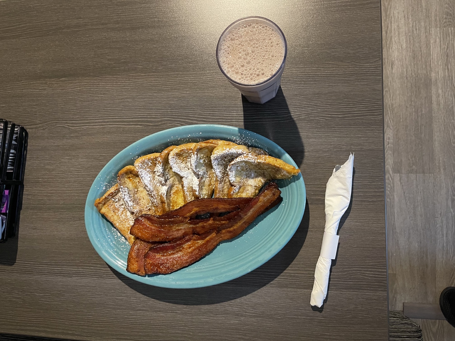 French toast, bacon, and a drink on a table